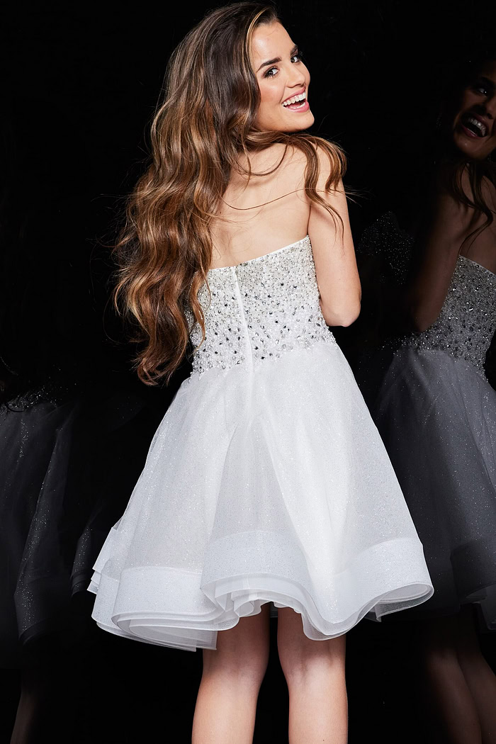 Back view of model wearing Jovani K24050 ivory dress with embellishments.