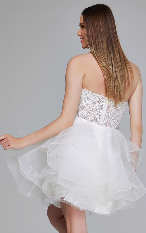 Model wearing Jovani 24371 white dress with intricate lace bodice and tulle skirt, back view.