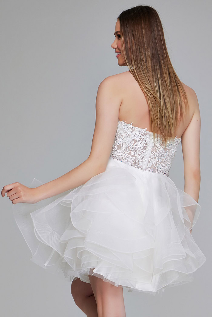 Model wearing Jovani 24371 white dress with intricate lace bodice and tulle skirt, back view.