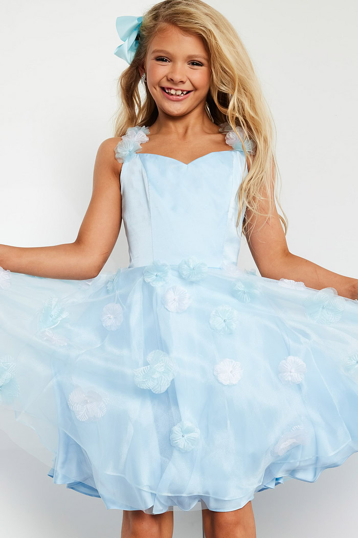 Model wearing K25989 blue dress with floral appliqués and sweetheart neckline