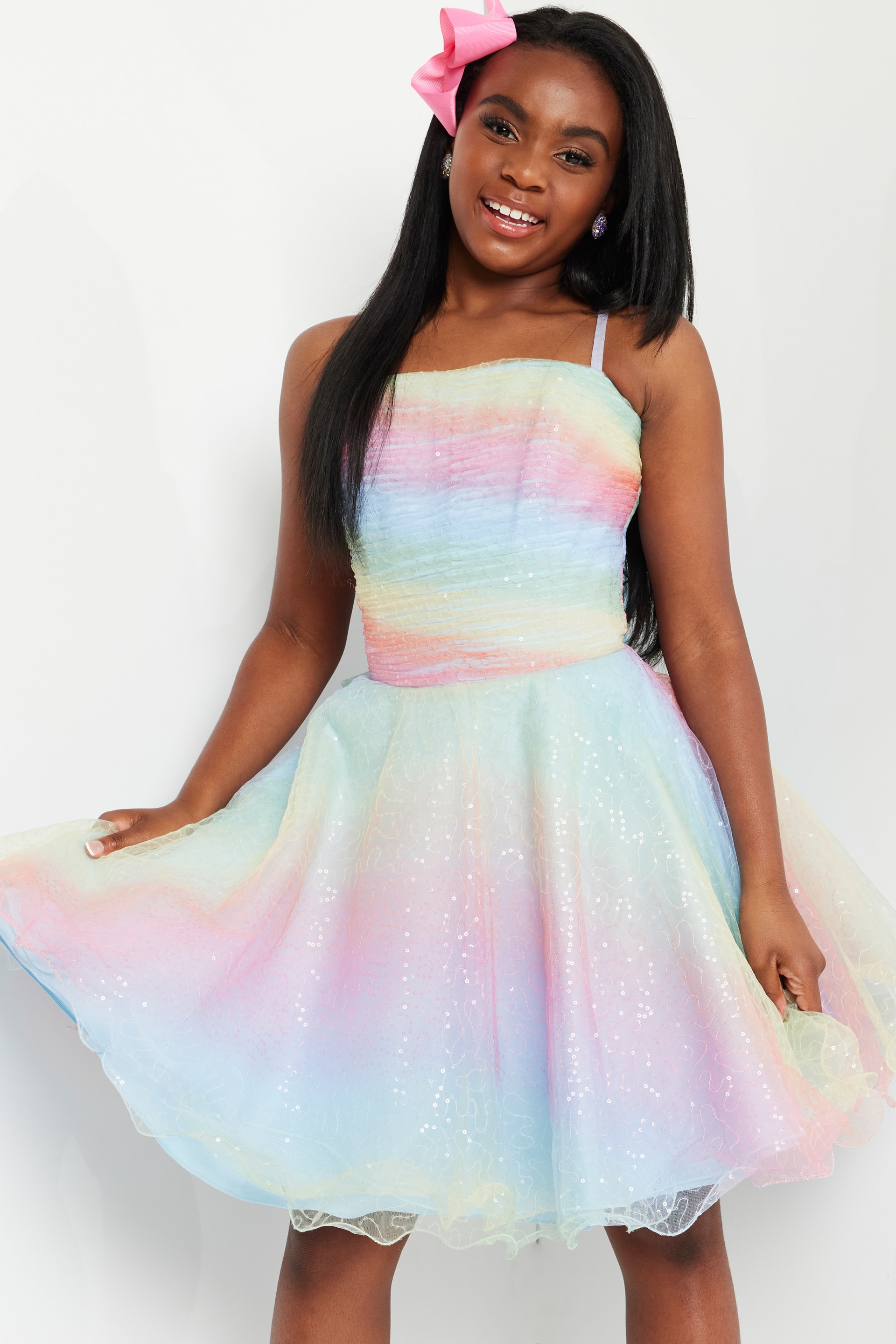 model wearing K36535 multi-color dress, playful pose