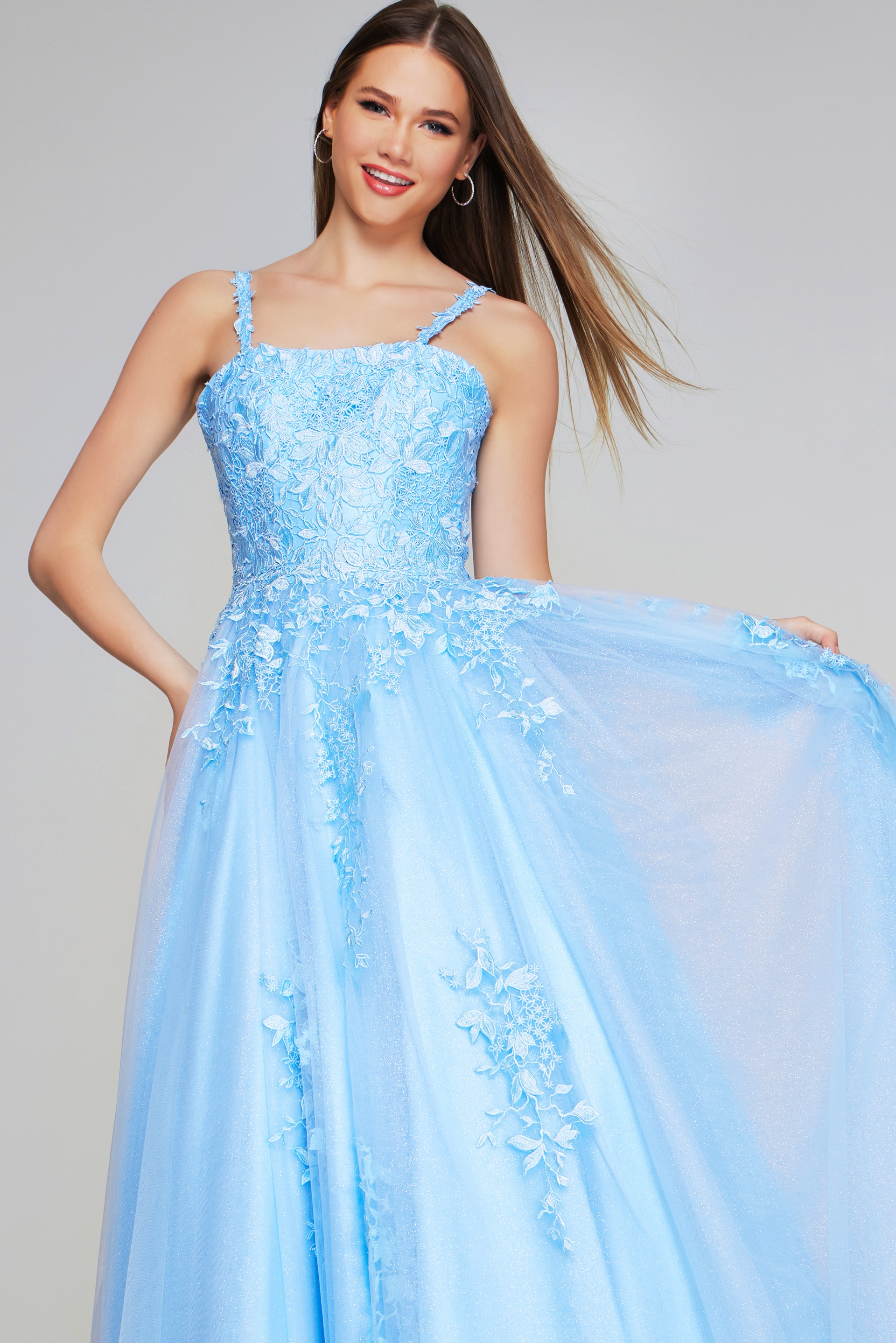 Model wearing Jovani K38098 light blue dress flaunting the floral appliqué design