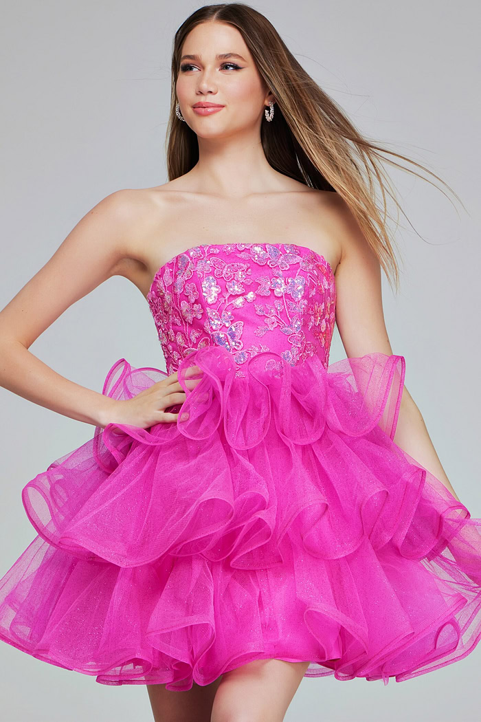 model wearing K38440 dress in pink with a strapless neckline and ruffled skirt
