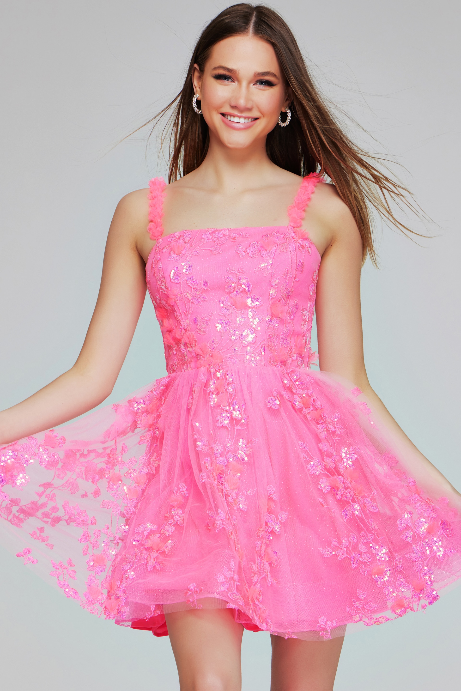 Model wearing K39141 pink dress with A-line silhouette and floral embellishments, front view.