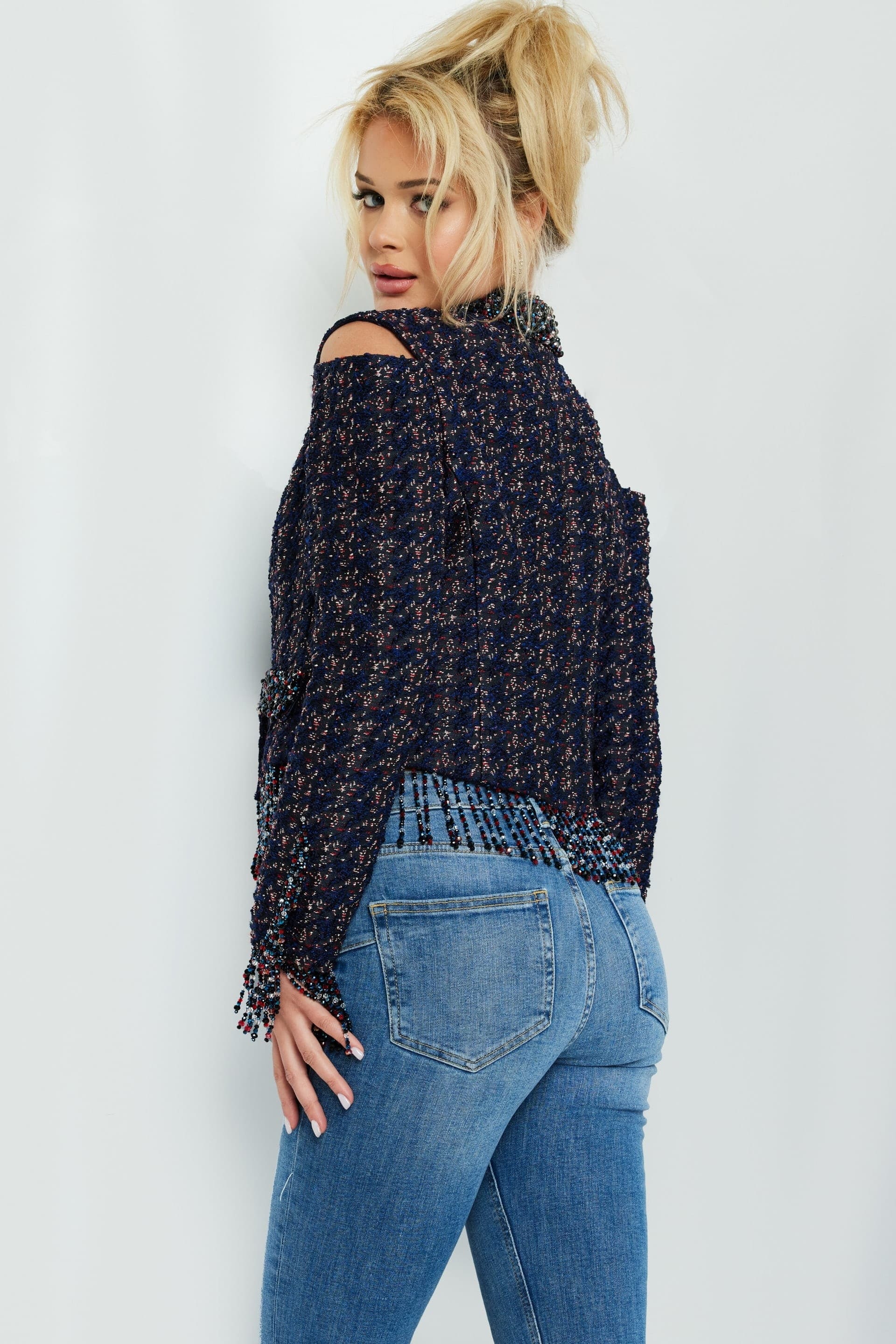 Back view of Jovani M61912 showing fringe details on sleeves and hem in multi.