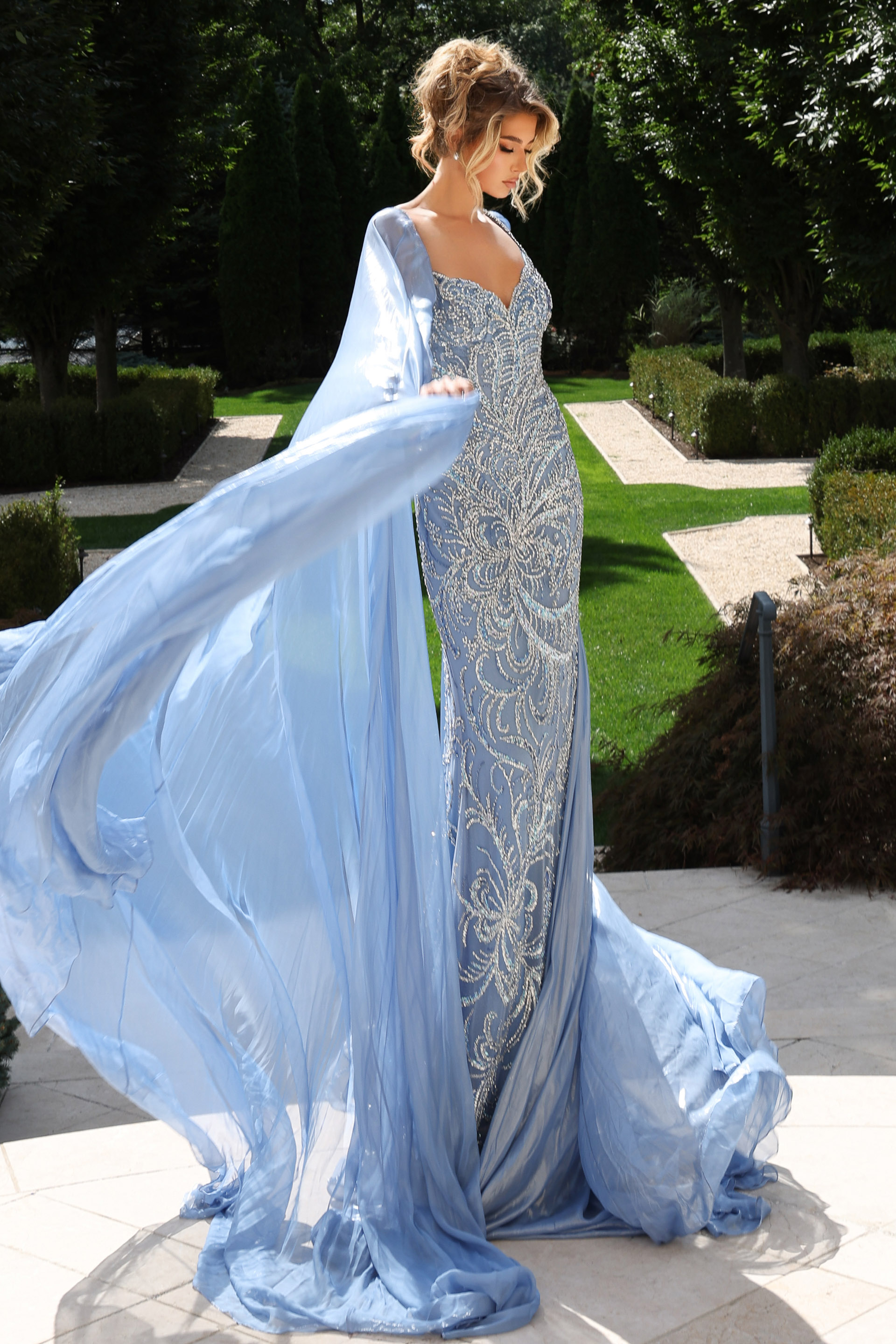 Elegant gown featuring crystal embroidery and flowing chiffon cape