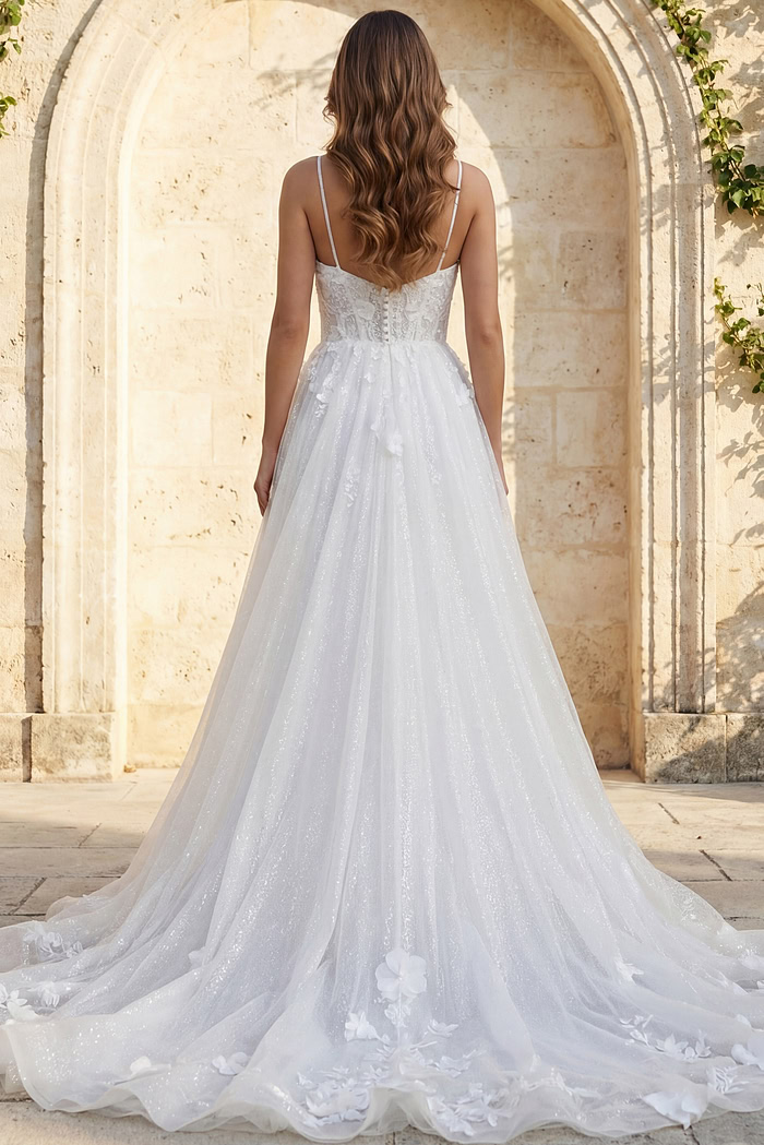 Back view of floral appliqué tulle bridal gown with thin straps and long flowing train