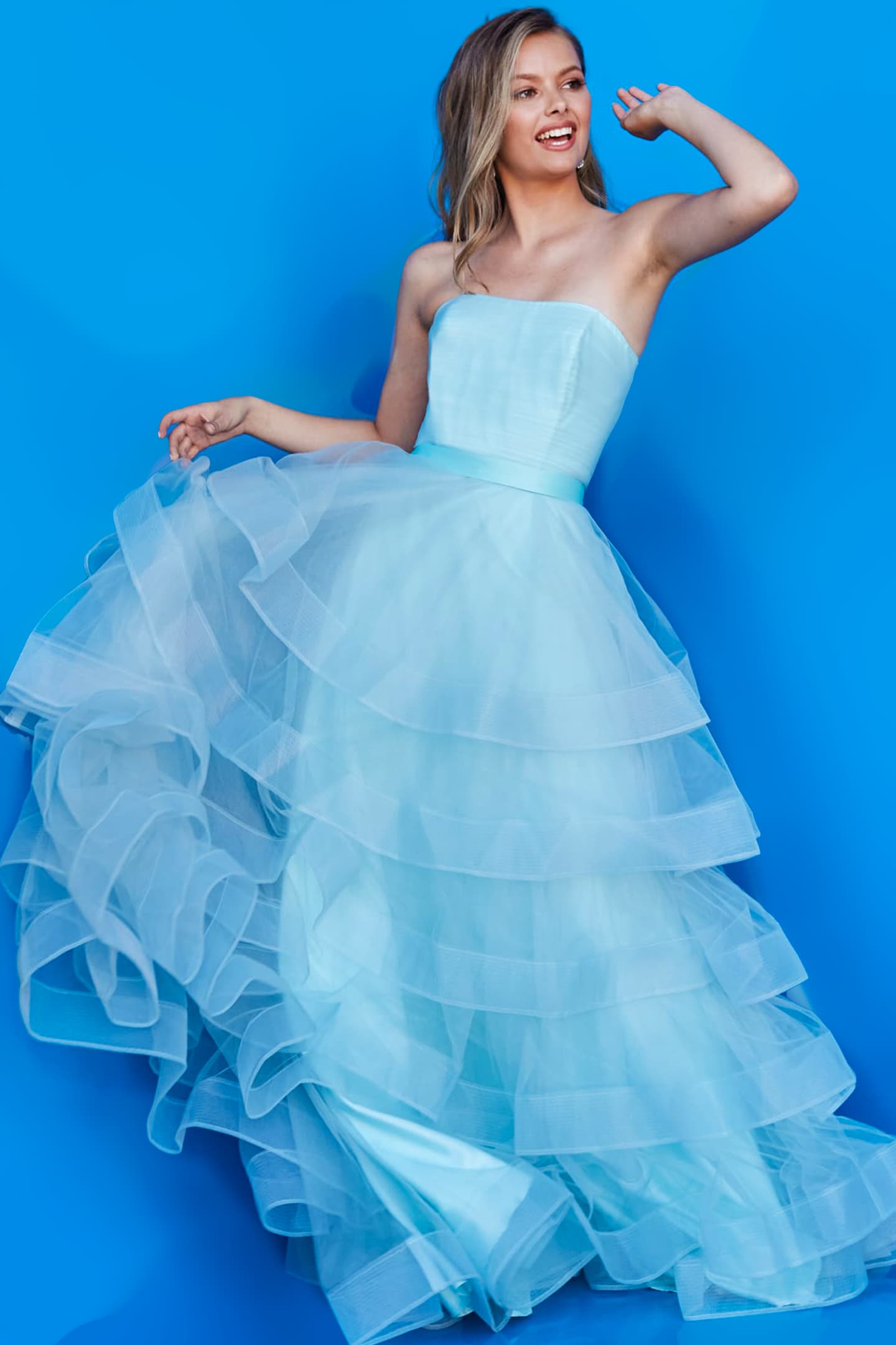 Model showcasing elegant Jovani K02442 blue dress, front view.