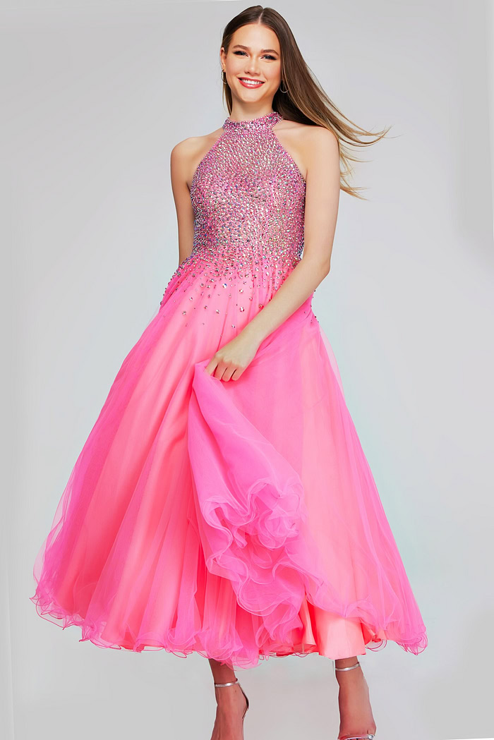 Model showcasing k38284 hot pink dress, highlighting the embellished bodice and flowing skirt, front angle.
