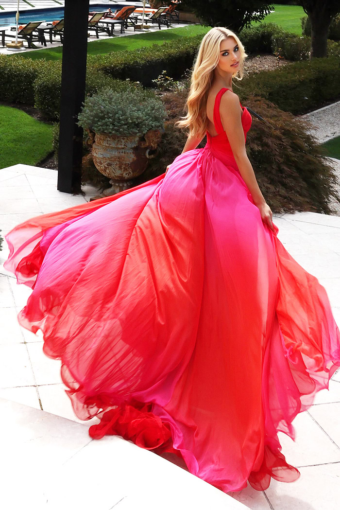Model wearing two-tone chiffon gown with ruched bodice and flowing skirt